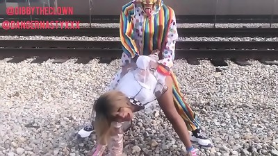 Clown pummels nymph on train tracks